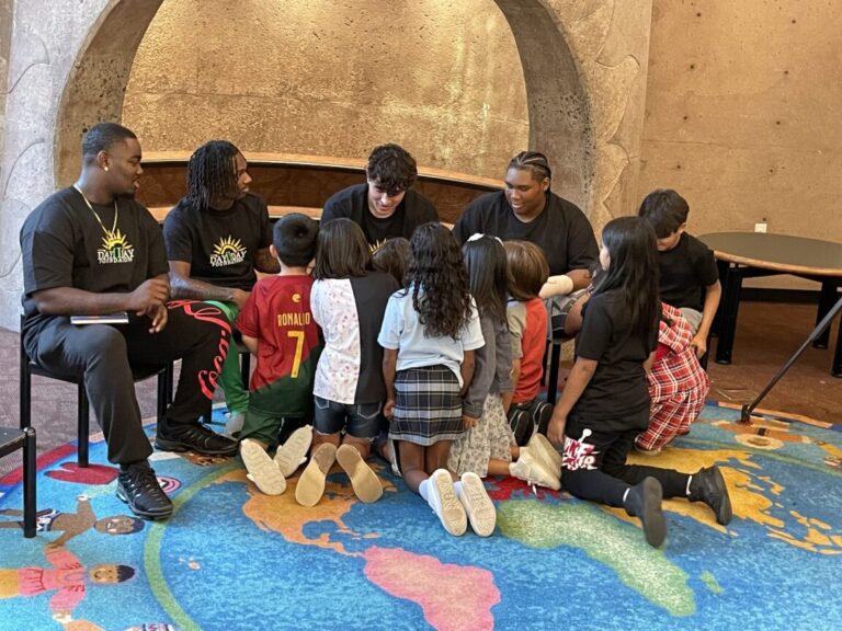 Lincoln High Footballers Reading to Kids