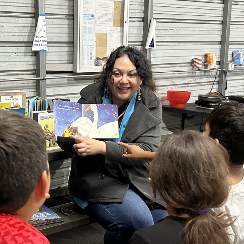 Reading Legacies team member Lucy reading to kids