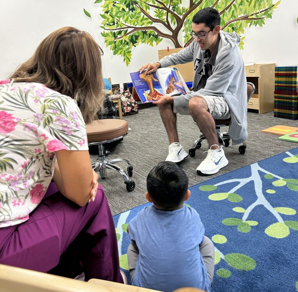 Reading Legacies Volunteer Reading at Family Story Hour